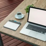 notebook em cima de uma mesa ao lado de tablet e uma xícara de café ilustrando o tema vantagens e desvantagens dos notebooks